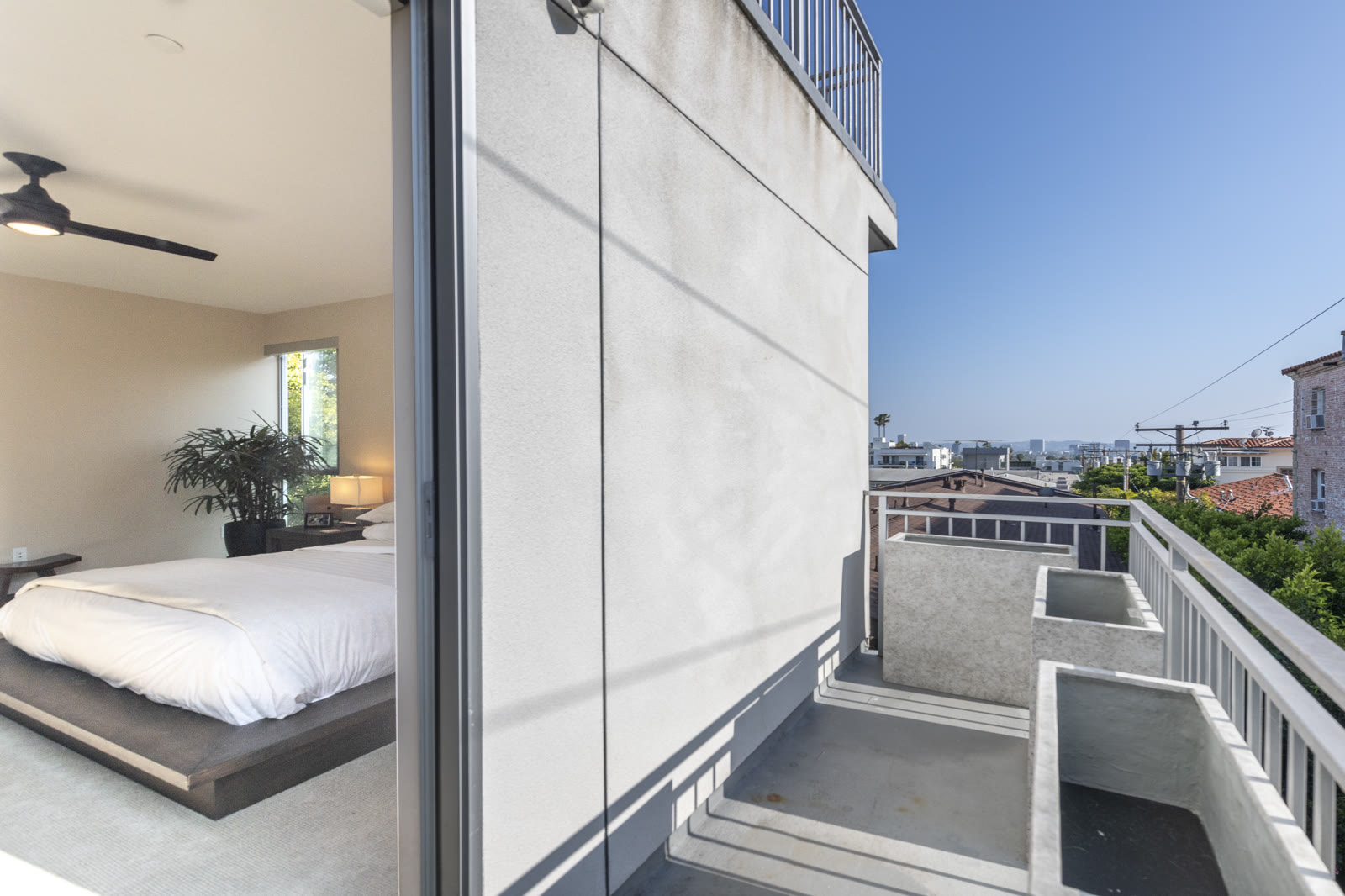 Primary bedroom opening to a private balcony